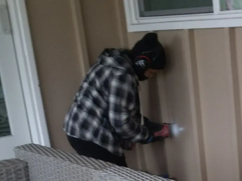 Professional electrician installing an exterior outlet in Hypoluxo